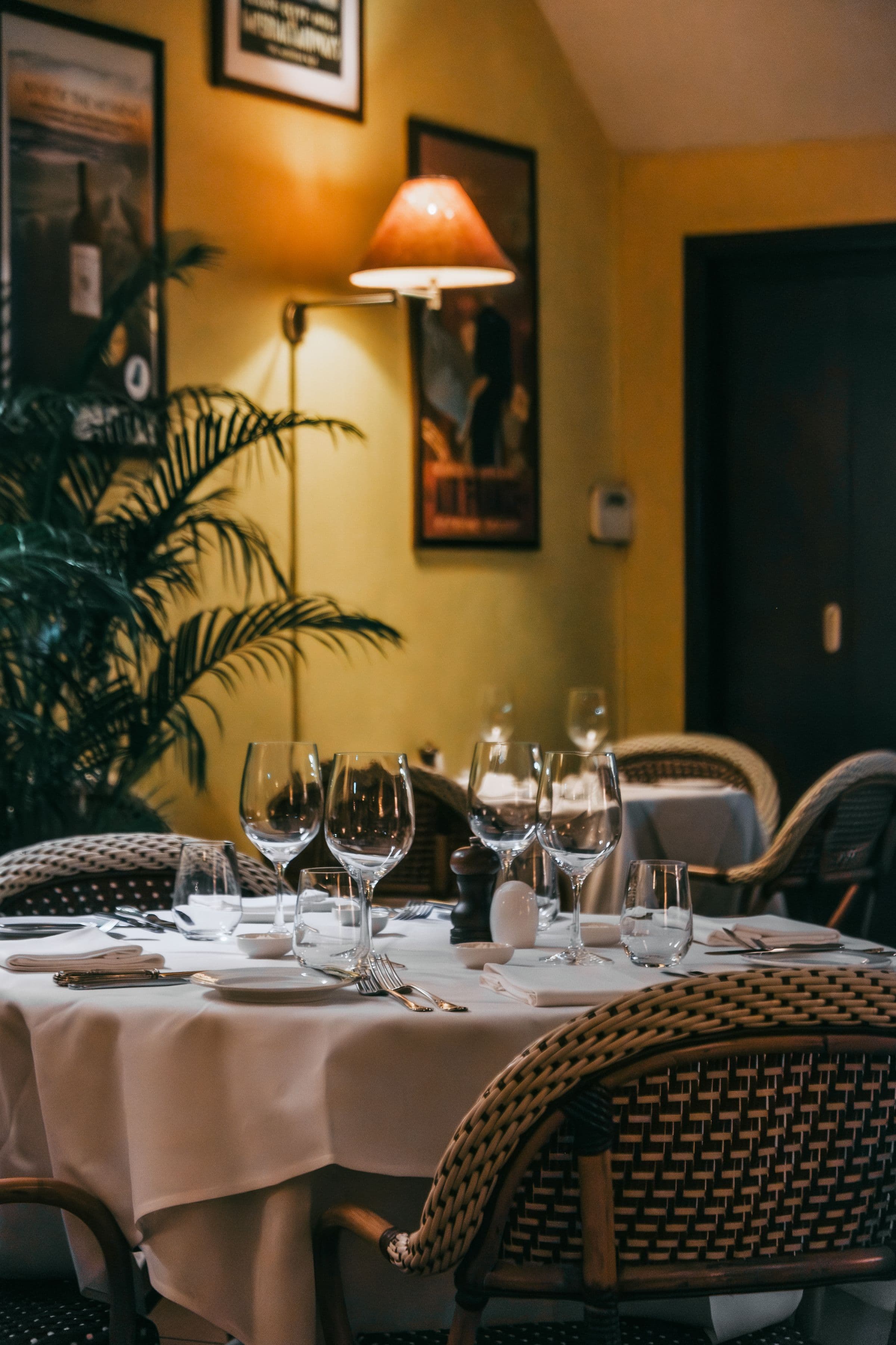 A warmly lit restaurant dining room during evening service